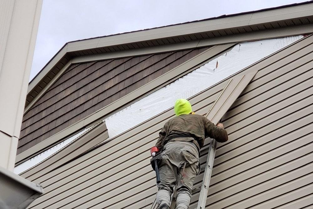 New siding installation transforming an older Minnesota home with improved exterior protection